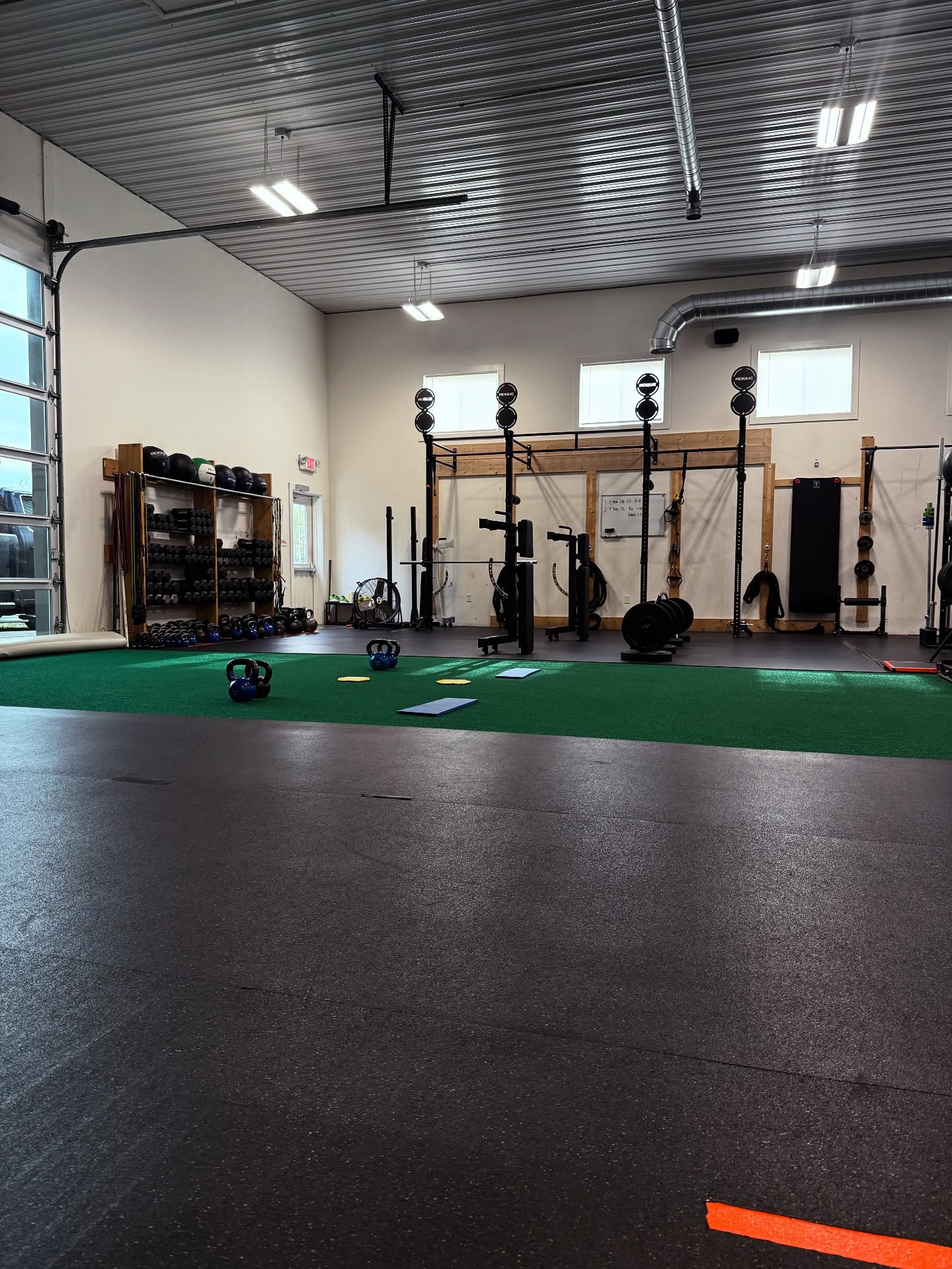Rukus Athletics gym floor with turf and equipment